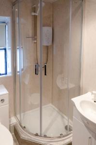a shower with a glass door in a bathroom at Thrums Hotel, Kirriemuir in Kirriemuir