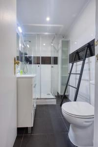 a bathroom with a white toilet and a shower at Lisbon Bica in Lisbon