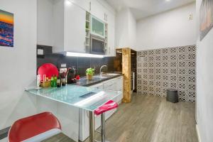 una cucina con bancone e sgabello rosso di Lisbon Bica a Lisbona