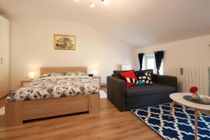 - une chambre avec un lit et une chaise dans l'établissement Sweet Loft Apartment "Blue" in Rijeka center, à Rijeka