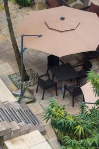an overhead view of a table and chairs with an umbrella at Radisson Lagos Ikeja in Lagos