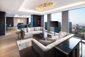 a living room with a couch and a dining room at Radisson Blu Hangzhou Xintiandi in Hangzhou