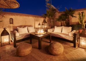 a living room filled with furniture and a table at Ryad Dyor in Marrakesh