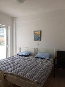 a bed with two blue pillows in a bedroom at MAREMARI VILLA in Ayía Marína