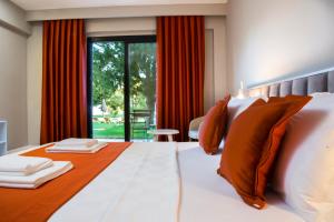 a bedroom with a large bed with orange and white pillows at Casa Elia Datça in Emecik +52 photos
