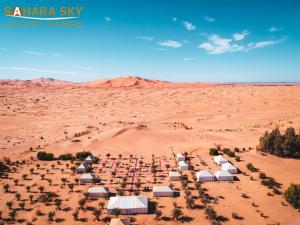 an aerial view of a desert with luxury tents at Sahara Sky Luxury Camp in Merzouga