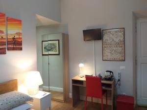 a bedroom with a desk and a bed and a desk with a lamp at B&B Acquamarina in Lido di Ostia