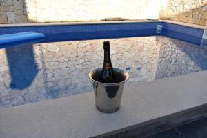 a bottle of wine in a bucket in a pool at Bella's House 4 com Piscina in Évora