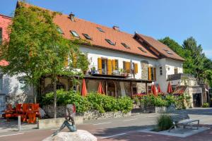 a statue of a woman walking in front of a building at Baderhaus in Bruck an der Mur