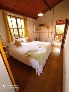 ein Schlafzimmer mit einem großen Bett in einem Zimmer in der Unterkunft Maloca Hospedagem in Sao Jorge