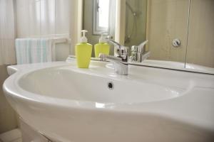 a white bathroom sink with two soap bottles on it at Case Vacanze Porto Vecchio in Lampedusa