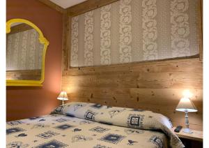 a bedroom with a bed and a wooden wall at Rêve en ville in Aosta