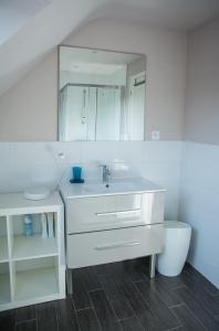 a white bathroom with a sink and a mirror at Cap sur Pen ar Valy à Plougoulm in Plougoulm +32 photos