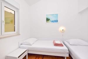 Postel nebo postele na pokoji v ubytování Apartment Marijana Baška