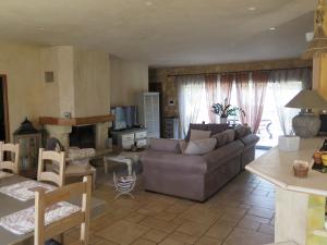 a living room with a couch and a table at Villa fiora classée 4 étoiles in Martigues