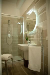 a bathroom with a sink and a shower and a mirror at Porta Aragonese Luxury Rooms in Palermo +57 photos