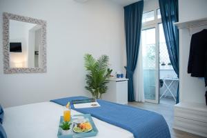 a hotel room with a tray of food on a bed at Porta Aragonese Luxury Rooms in Palermo