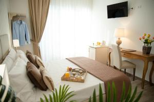 a hotel room with a bed and a desk and a desk at Porta Aragonese Luxury Rooms in Palermo