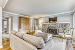 a living room with a couch and a stone fireplace at Bee Branch 07 in Sugar Mountain