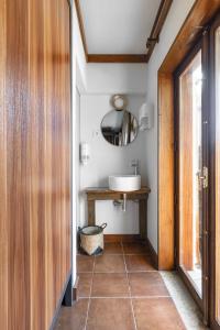 a bathroom with a sink, toilet and a window at Selina Gerês in Geres