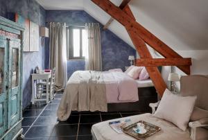 a bedroom with a bed and a couch in a room at Gasterie Lieve Hemel in Sevenum