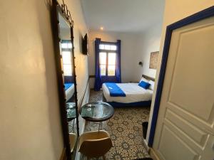 Postel nebo postele na pokoji v ubytování Hôtel Central