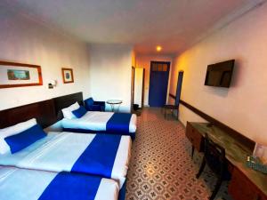 Postel nebo postele na pokoji v ubytování Hôtel Central