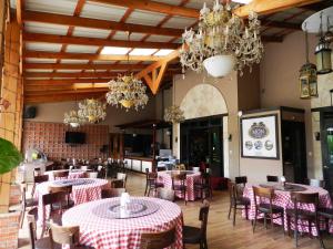 a restaurant with tables and chairs and chandeliers at MON Hotel Boutique in Constanza