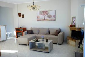 a living room with a couch and a coffee table at Petra's House in Polychrono