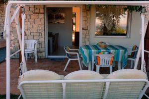a table and chairs on the back porch of a house at Petra's House in Polychrono