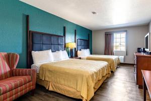 a hotel room with two beds and a couch at Americas Best Value Inn - Temple in Temple +29 photos
