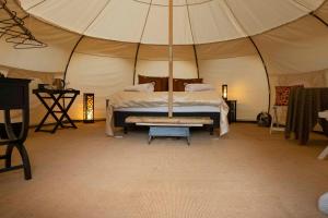 a bedroom with a bed in a tent at Kerikeri Glamping in Kerikeri