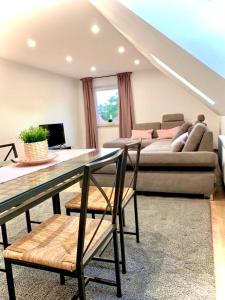 a living room with a table and a couch at Airport & Messe Apartments in Hannover