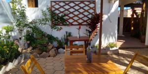 a patio with a table and a bench in a house at Pousada Rio Sagi in Baía Formosa