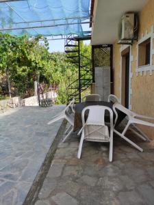 a table and chairs sitting on a patio at Elpida Apartment in Limenas