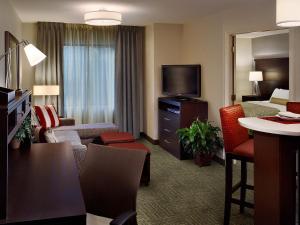 a hotel suite with a living room with a bed and a television at Staybridge Suites - Pittsburgh-Cranberry Township, an IHG Hotel in Warrendale