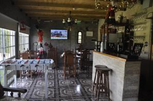 a restaurant with a bar with a table and chairs at Posada La Pausa - Solo para Adultos in Miramar