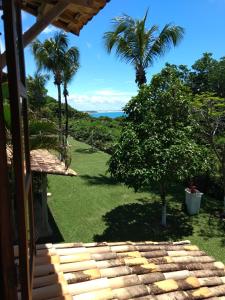 琵琶的住宿－Chalé Colibri Vista Mar Condominio Varandas de Pipa，享有棕榈树房子庭院的景色