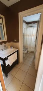 a bathroom with a sink and a toilet at Lala's Home in Ushuaia