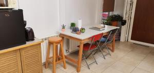 a kitchen with a small table and some chairs at Lala's Home in Ushuaia +29 photos