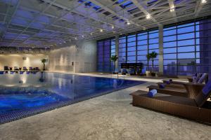 a large swimming pool in a large building at Crowne Plaza Beijing Chaoyang U-Town, an IHG Hotel in Beijing