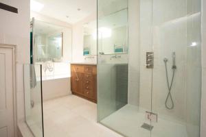 a bathroom with a shower and a glass shower stall at Medieval Town House - Walled Garden Sleeps 8 in Rye