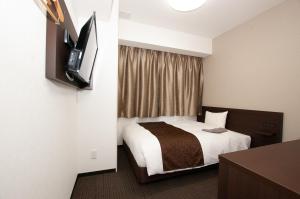 Ένα ή περισσότερα κρεβάτια σε δωμάτιο στο AI HOTEL Hashimoto