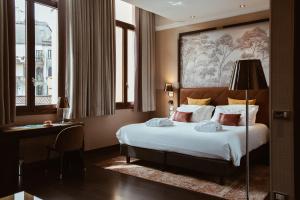 a hotel room with a large bed and a large window at Hotel Indigo Venice - Sant'Elena, an IHG Hotel in Venice