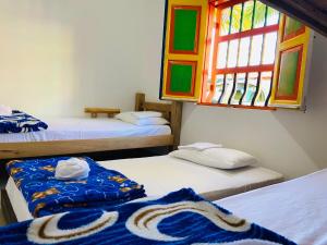 מיטה או מיטות בחדר ב-casa hostal las palmeras
