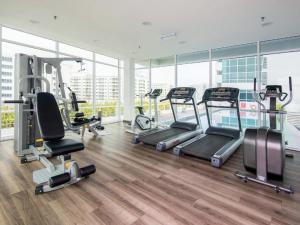 un gimnasio con varias cintas de correr y máquinas elípticas en Maritime Luxury Suite By J&K Homestay, en George Town