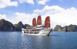 a cruise ship with red sails on the water at Alisa Premier Cruise in Ha Long