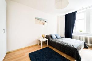 a bedroom with a bed and a rug and a window at 3 Rooms BIG Apartment - 150 m Town Hall - Nice Design in Wrocław