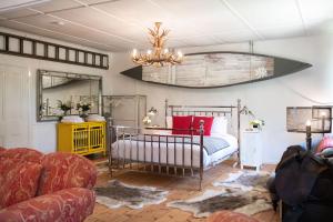 a bedroom with a bed and a couch and a chandelier at Pirralilla Estate Adelaide Hills in Aldgate +60 photos