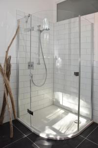 a shower with a glass door in a bathroom at Historischer Bahnhof in Friedrichshafen